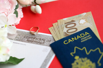 Canadian Certificate of marriage document and wedding ring with canadian dollars and passport close up