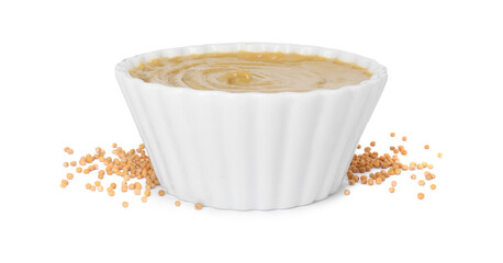 Fresh tasty mustard sauce in bowl and dry seeds isolated on white