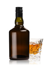 Glass and bottle of whiskey isolated on white