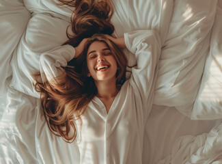 Close up of a happy young woman laying in bed with long hair on a white pillow, feeling of a morning waking, concept of good health, top view, high resolution, high quality image