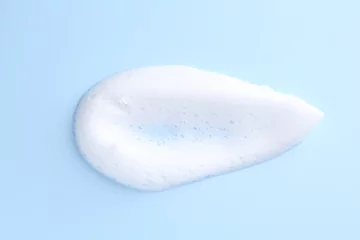 Foto op Plexiglas Sample of fluffy foam on light blue background, top view © New Africa