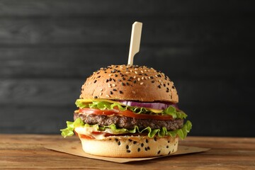 Burger with delicious patty on wooden table