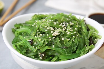 Tasty seaweed salad in bowl on table, closeup