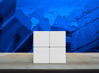 Four white block cubes on wooden table over world map, modern office city tower and skyscraper, Elements of this image furnished by NASA