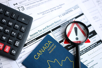 Fototapeta premium Concept of problems and troubles during tax reporting and taxpaying in Canada. Accountant table with canadian tax forms