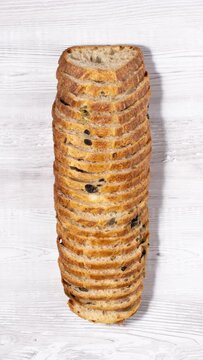 Stop motion of fresh bread slices disappearing and appearing at wooden board. Vertical video