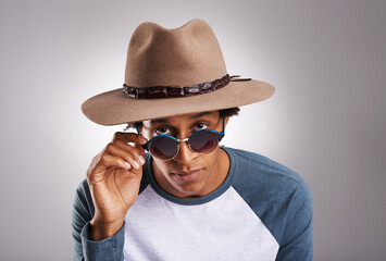 Black man, hat or glasses in vacation, fashion or portrait of confidence on grey studio background....