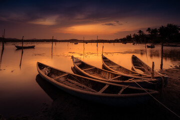 Fototapeta na wymiar Traditional boats at O Loan lagoon in sunset, Phu Yen province, Vietnam