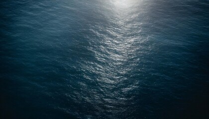 aerial view of surface of deep dark blue sea with reflection of the sun s rays as background for...