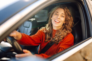Portrait of young woman is driving. Leisure, travel, weekend, navigation.