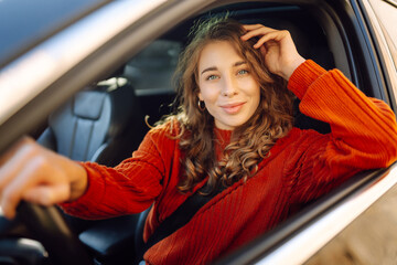 Portrait of young woman is driving. Leisure, travel, weekend, navigation.