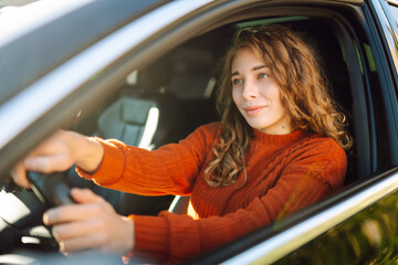Portrait of young woman is driving. Leisure, travel, weekend, navigation.