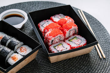 Takeaway Japanese food on paper boxes. Sushi in box lunches.