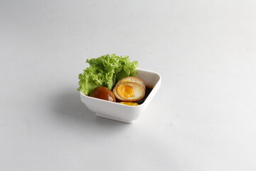 dark soy sauce japanese lava braised chicken egg yolk chinese herbal tea in bowl on white table...