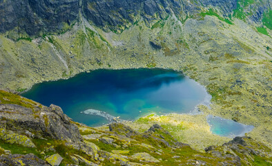 small emerald lake in mountain bowl