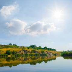 Fototapeta na wymiar small calm river at the sunny day, summer countryside landscape