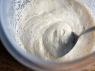 scooping sourdough bread starter