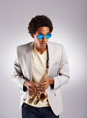 Man, fashion and jazz with saxophone in studio from trendy sunglasses with instrument as musician....