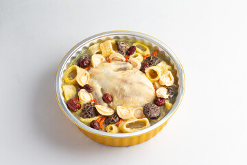 freshly hot stewed whole kampong chicken with abalone seafood in clay pot herbal soup on white table hotel chinese new year banquet restaurant halal food cafe menu