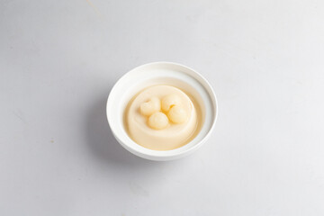 ice cold cute milk almond soya bean curd pudding jelly on plate with longan lychee fruit decor on white table sweet cafe banquet asian restaurant dessert halal kids food menu