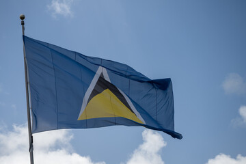St lucia flag flying in a blue sky