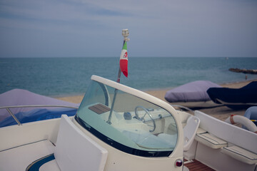 Boat windshield with a small Italian flag on top
