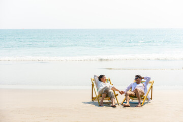 Happy Asian family senior couple enjoy outdoor lifestyle on summer beach holiday vacation at the...