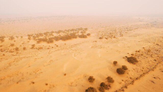Incredible aerial shot of Thar desert landscape in Jaisalmer, Rajasthan, India. 4K video of Sam Sand Dunes. Arid dry climate of Rajasthan during summer season. Nature landscape.