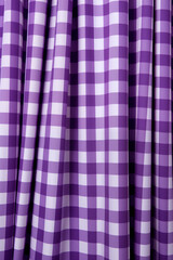 Close-Up of Purple and White Checkered Fabric. Soft, stretchy material creates a textured backdrop, perfect for a variety of design projects. The classic checkered pattern