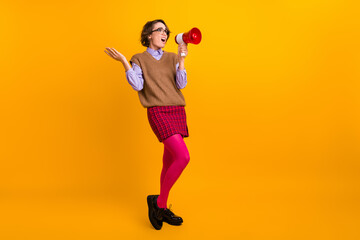 Photo portrait of attractive young woman moody scream megaphone dressed retro office clothes isolated on yellow color background