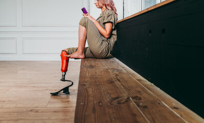 Amputated woman. Cinematic image of a beautiful young woman with leg prosthesis.