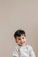 Portrait of a smiling boy on a beige background
