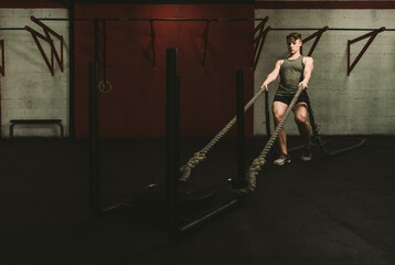Fototapeta na wymiar Beautiful young woman training at the gym