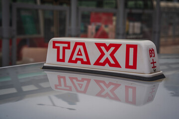Taxi sign Hong Kong - reflection red letters on the hood