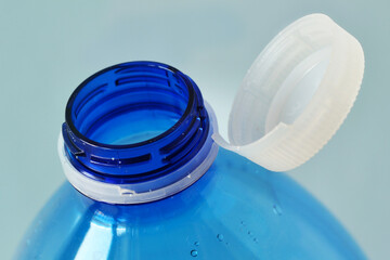 Close-up of cap attached to the neck of the plastic water bottle