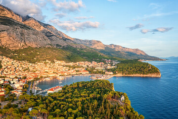 Aerial view of the harbor and old town of Makarska, Dalmatia, Croatia. Summer landscape with yachts, sea, architecture and rocks, famous tourist destination at Adriatic seacoast, travel background