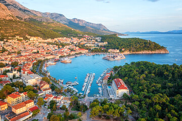 Aerial view of the harbor and old town of Makarska, Dalmatia, Croatia. Summer landscape with yachts, sea, architecture and rocks, famous tourist destination at Adriatic seacoast, travel background - 781161879