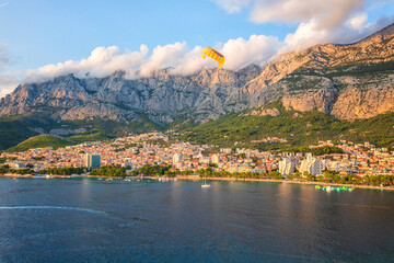 Beautiful aerial view of the town of Makarska, Dalmatia, Croatia. Summer landscape with yachts, sea, architecture and rocks, famous tourist destination at Adriatic seacoast, travel background