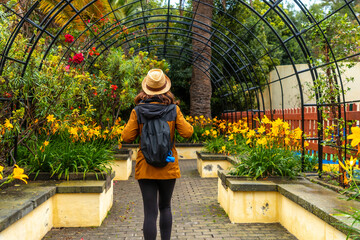 A woman walking through a beautiful botanical garden, a sustainable tourism concept in Arucas, Gran...