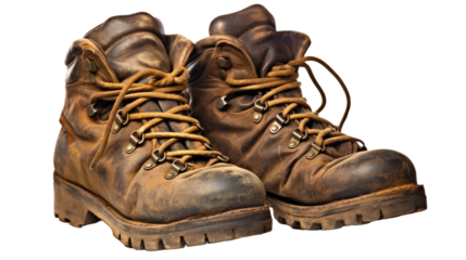 A pair of well worn old leather hiking boots used to protect your feet when walking in the mountains isolated against a white background
