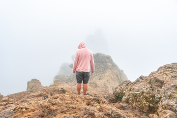 Naklejka premium A tourist visiting the very cloudy Pico de las Nieves in Gran Canaria, Canary Islands. Spain