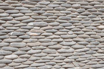 stone pavement with rounded blocks and soil between - 781166209