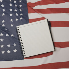 Obraz premium Top view of fireworks for independence day with American flags and notebook