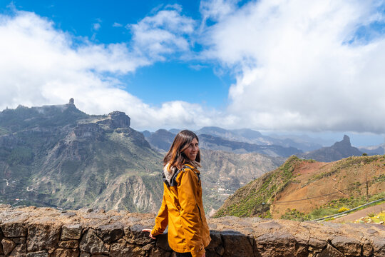 Portrait of a woman looking at Roque Nublo from a viewpoint on the mountain. Gran Canaria, Spain