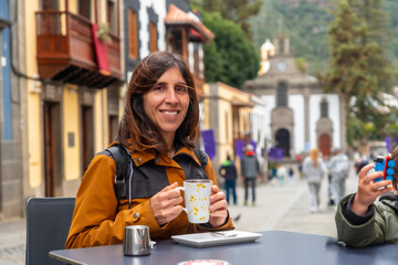 A tourist woman resting and having a coffee in the municipality of Teror. Gran Canaria, Spain