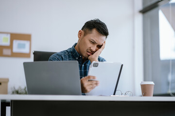 stressed asian businessman working in the office. Businessman thinking too much work concept in the office.