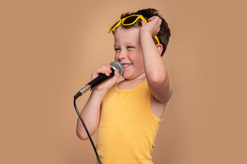 Young boy enjoying singing with a microphone