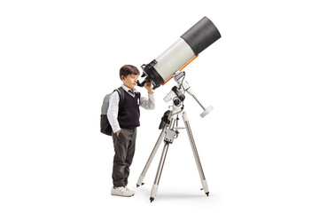 Schoolboy observing the planets and stars with a telescope