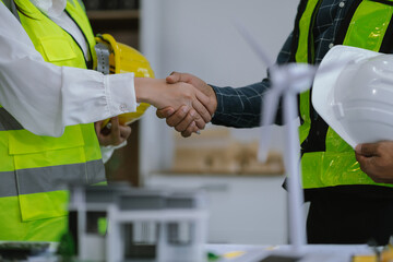 architects and engineers shake hands while working for teamwork and cooperation after completing an agreement in an office facility, successful cooperation concept.
