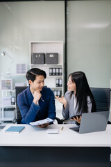 Portrait of success business people working together in office. Couple teamwork startup concept. © Nuttapong punna